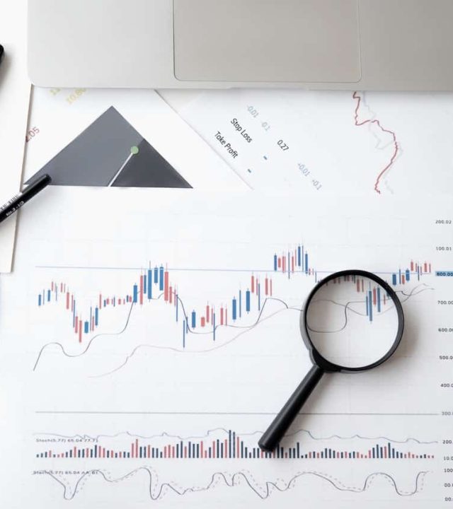 Magnifying lens sitting on charts during an exam session